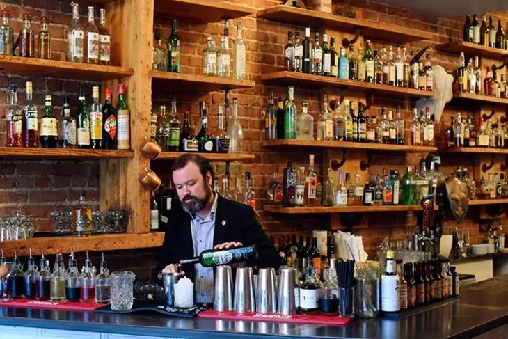 Chris Barrett makes a cocktail at Ludivine, Monday, April 11, 2016. - GARETT FISBECK
