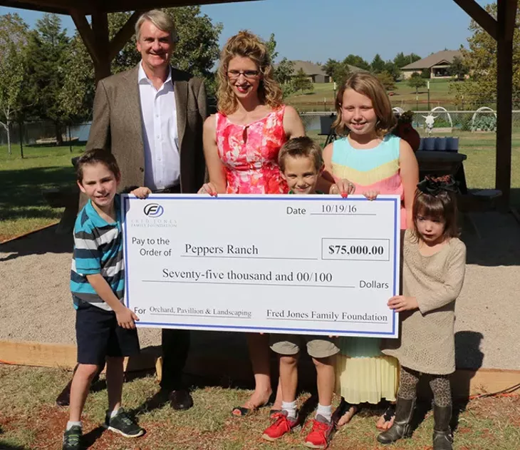 Kirk Hall, President of the Fred Jones Family Foundation presents Tonya Ratcliff, Executive Director of Pepper Ranch, with a check for $75,000 for the 2016 Mary Eddy Jones Signature Gift.