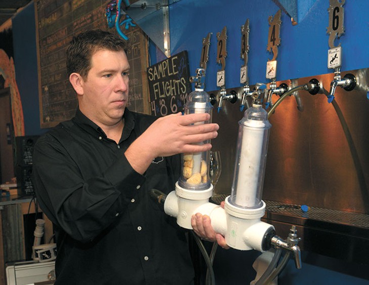 Blaine Stansel loads a randel beer infuser with savannah smiles at Roughtail Brewing Co. in Midwest City. (Garett Fisbeck)