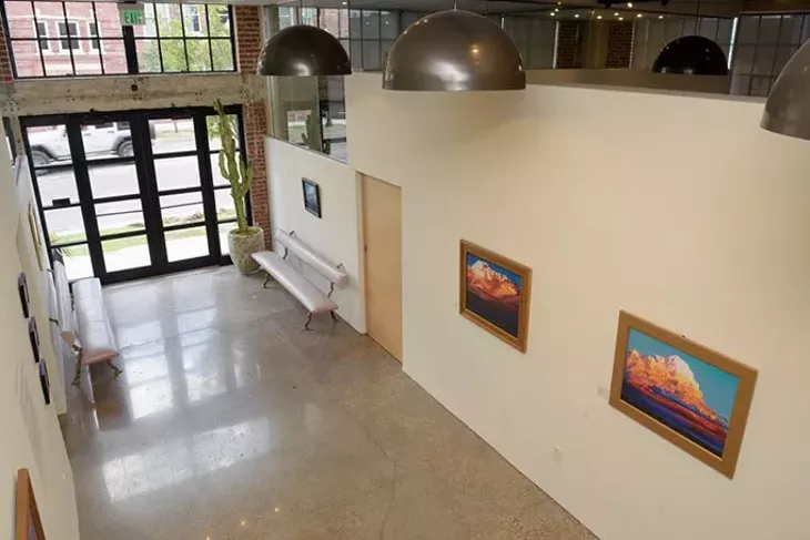 Works from David Holland’s Cloudscapes hang in FG Gallery, part of the Fulmer Sill law firm. (Garett Fisbeck)