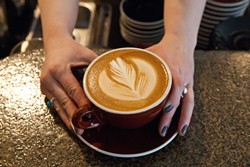 A fresh latte made by barista Tori Goben, at Coffee Slingers Roasters.  mh