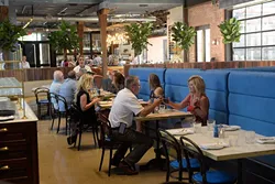 Patrons of The Jones Assembly toast during the dinner hour on July 13. The Jones Assembly is a restaurant, bar, live music and event venue that occupies a former warehouse in Oklahoma City’s Film Row. (Garett Fisbeck)
