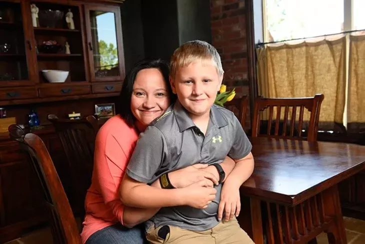 Wendy Elliott and her song, Adam, 9, pose for a photo at their home in Mustang, Wednesday, May 4, 2016. - GARETT FISBECK
