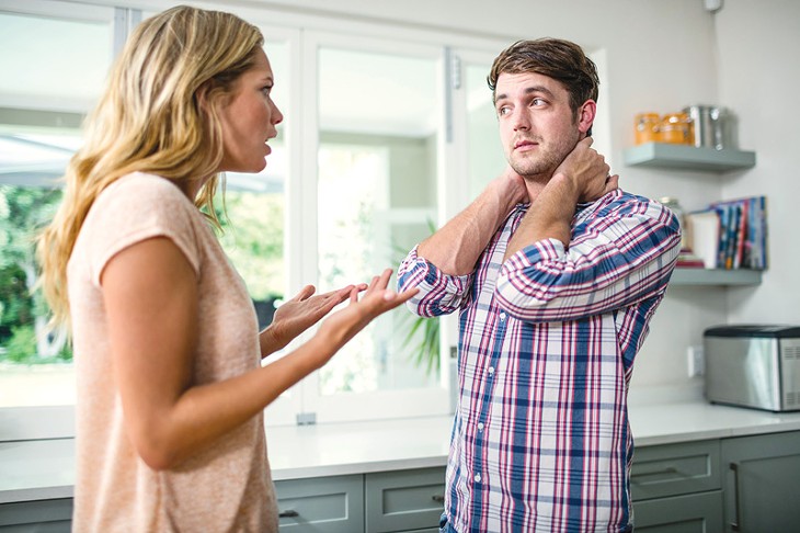 Upset couple having an argument in the kitchen - BIGSTOCK