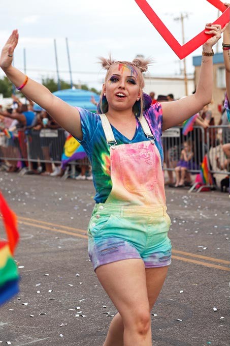 A girl dressed in tie-dye walks with the JCPenny float during the Pride Parade on Sunday, June 25, 2017. (Cara Johnson).