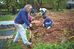 CommonWealth Urban Farms of OKC cofounder and farm manager Elia Woods and volunteers prepare soil for new planting beds. (Photo Bo Apitz / provided)