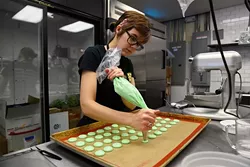 ?Kaci Messerly pipes macarons at Belle Kitchen, Tuesday, May 10, 2016. - GARETT FISBECK