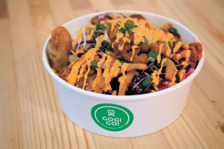 A combination bowl features grilled chicken, bulgogi beef, spicy pork, rice, japchae and toppings. | Photo Jacob Threadgill