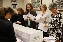 Frances Kersey, city clerk of Oklahoma City (far left) is joined by other city employees reviewing the initiative petitions competed by Save OKC Schools coalition. (Photo Laura Eastes)