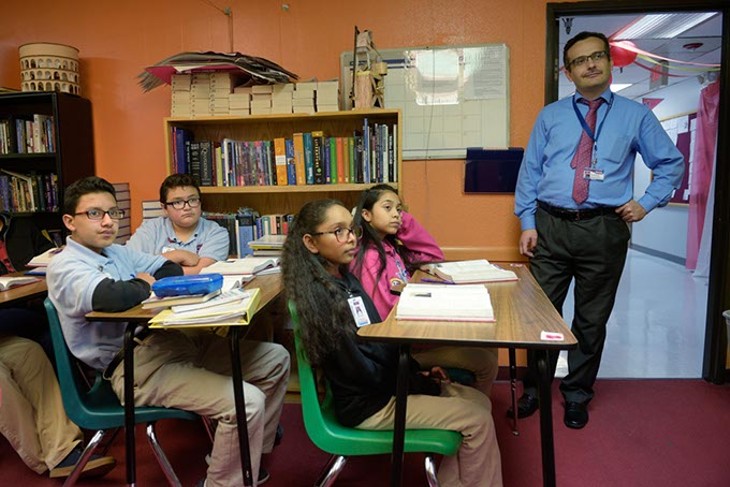 Superintendent Umit Alpasian observes a seventh-grade English class at Dove Science Academy, which was one of six Oklahoma schools named a National Blue Ribbon School in 2017. (Photo Garett Fisbeck)
