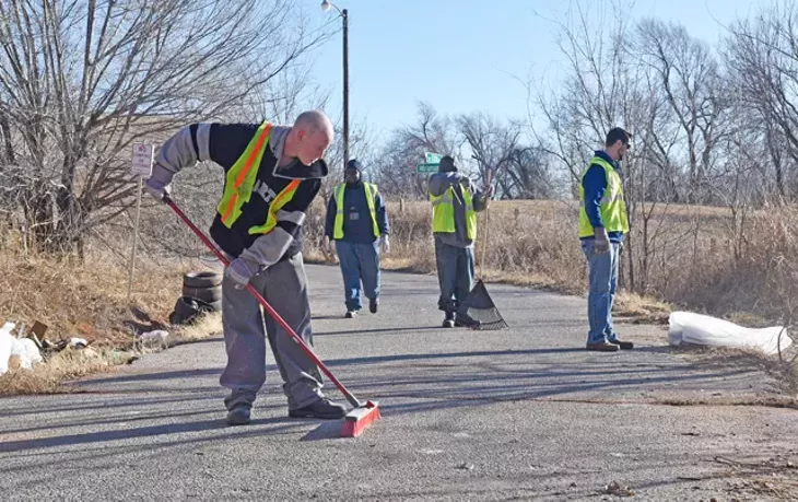 Participants in the Center for Employment Opportunities remove debris from an illegal dumpsite in northeast Oklahoma City. (Photo Laura Eastes)
