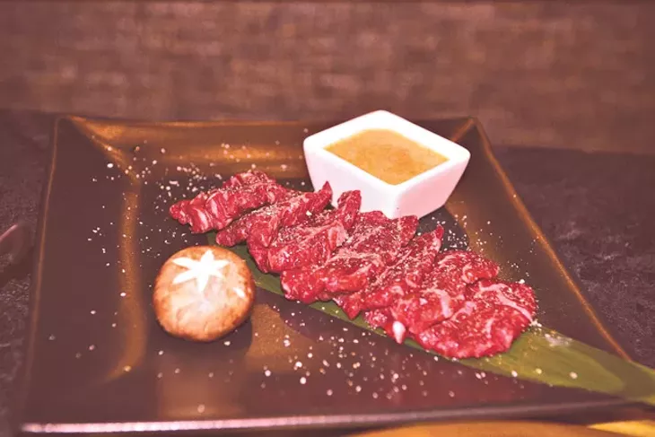 The prime filet is infused with applewood smoke that pours out when brought to the table. (Jacob Theadgill)