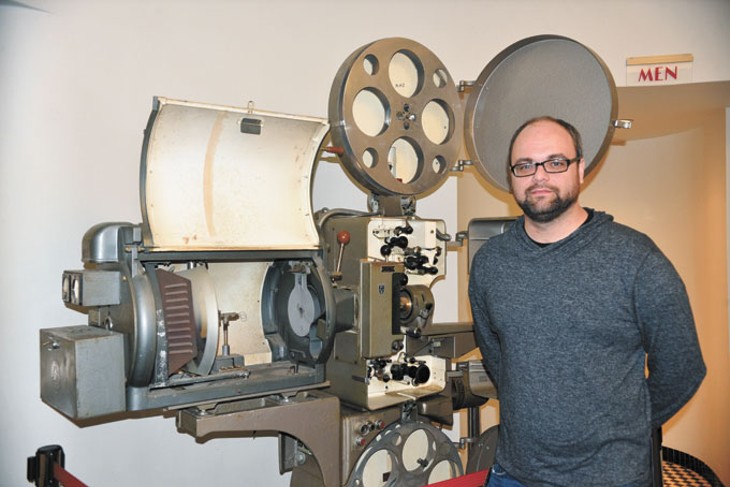 Tower Theatre operator Stephen Tyler shows the one of theater&#146;s original projector. | Photo Jacob Threadgill