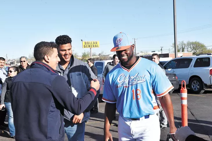 Oklahoma City Dodgers fans interact with college baseball player Juan Fuentes wearing the new Cielo Azul jersey. - LAURA EASTES