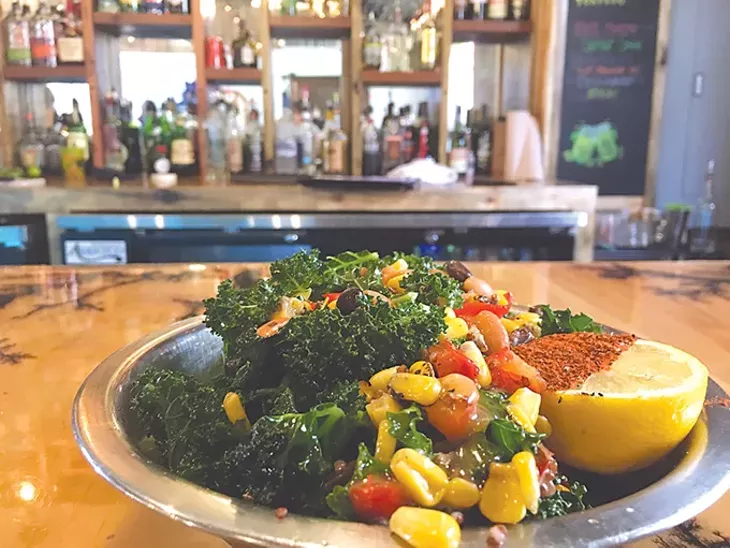 A massaged kale salad with corn, black and pinto beans, red bell peppers, lemon, quinoa and house dressing. - JACOB THREADGILL