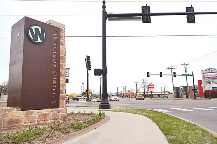 A streetscape revitalization project brought markers to The Windsor District, including this 11-foot-tall “W” backlit with an LED beam that now stands at NW 23rd Street and Meridian Avenue. - LAURA EASTES