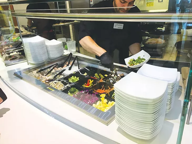 Guests choose which vegetables and protein - to pair with either rice or noodles at the Asian bowl station in Nebu. - JACOB THREADGILL