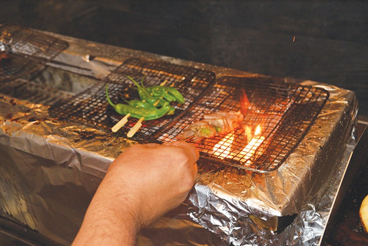 The charcoal grill at Ok-Yaki reaches temperatures up to 900 degrees Fahrenheit. - JACOB THREADGILL