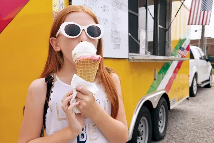 Emery, 11, indulges in a double scoop of Just Desserts’ non-dairy ice cream. - JACOB THREADGILL