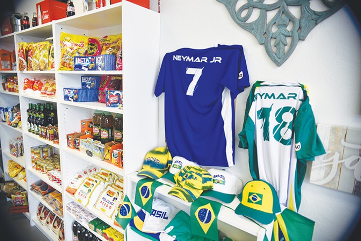 Brazilian memorabilia sits next to a market of dry goods and candy at Moore de Brasil. - JACOB THREADGILL