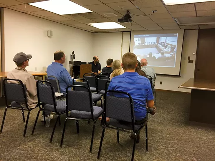 Members of the public watch a live broadcast of the special State Board of Health meeting Aug. 1 - BEN LUSCHEN