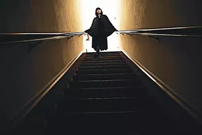 Mary Buss descends a staircase in Strike, Dear Mistress, and Cure His Heart, screening 8 p.m. Oct. 18 at Rodeo Cinema. - PROVIDED
