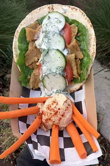 A seitan-based gyro served with tzatziki sauce and a side of hummus - JACOB THREADGILL