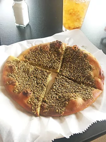 Za’atar pie served on manakeesh flatbread - JACOB THREADGILL