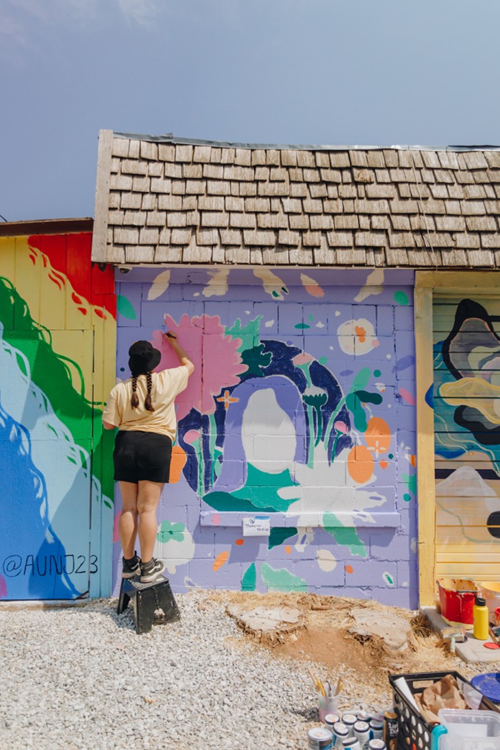 Thumy Phan works on her mural during the 2021 Sunny Dayz Mural Festival. - STEPH MONTELONGO
