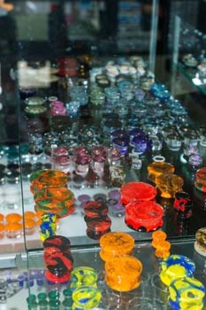 Display cabinet of various ear plugs at 23rd Street Body Piercing in Oklahoma City. Best place to get needled 2015. Thursday, August 6, 2015. (Keaton Draper)