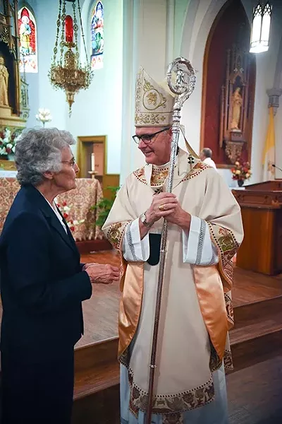 Sister Marita Rother chats with Most Reverend Paul Coakley, Archbishop of Oklahoma City, after the Anniversary Mass for Father Stanley Rother at the Holy Trinity Catholic Churche in Okarche Oklahoma on Aug. 1. mh