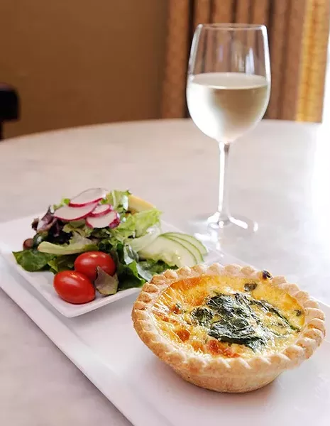 Quiche florentine, side salad, and white wine at La Baguette Bistro in Oklahoma City, Wednesday, Jan. 28, 2015. - GARETT FISBECK