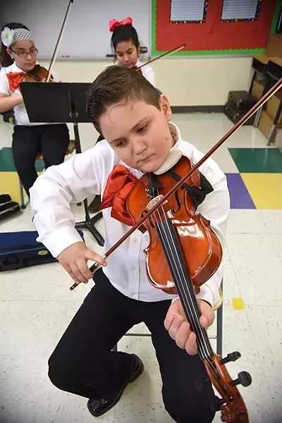 Mariachi student playing a song in Christiaan Osborn's class at Filmore Elementary School in South Oklahoma City, 1-15-16. - MARK HANCOCK