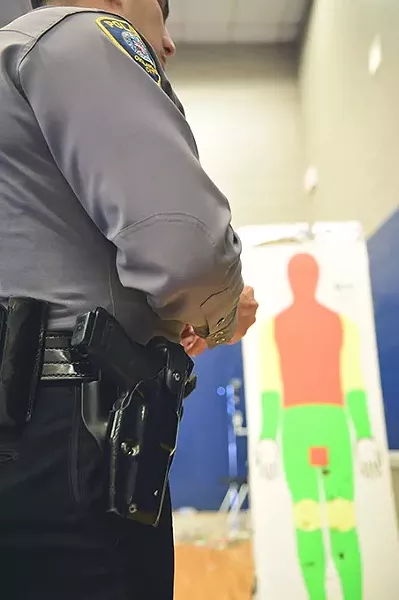Captain Paco Balderrama's holster and gun with taser target in background, at the OKC Police Training Center. mh