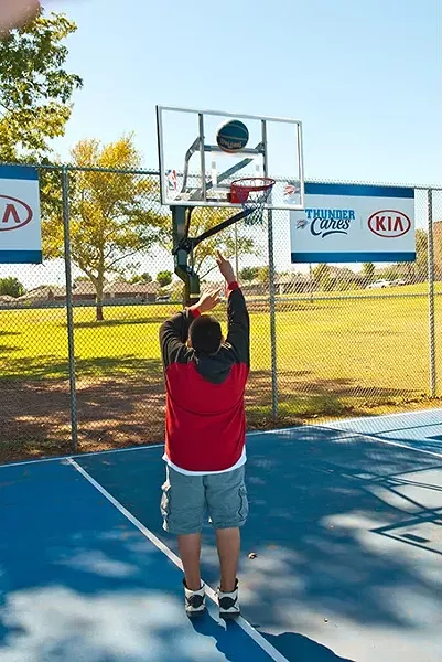 A boy plays basketball on the newly referbished court at Schilling Park off SE 25th Street. mh