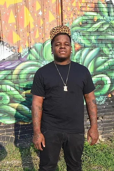 Jabee, local hiphop artist, photographed in front of the parking lot mural off NW 9th Street east of Broadway Avenue, in OKC, 8-26-15. - MARK HANCOCK