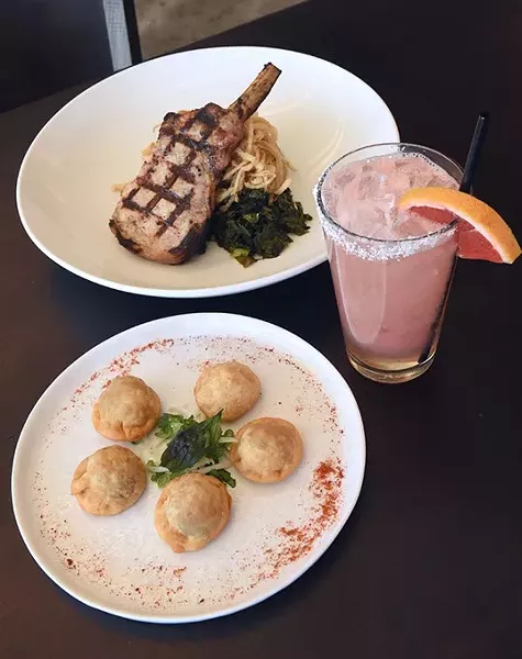 Pork Chop with noodles and greens, and up front, Oxtail Ravioli, with a Paloma cocktail, at Guernsey Park. mh