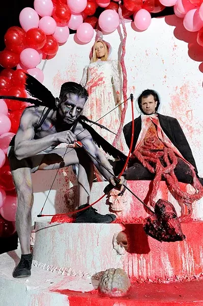 Juan Rios, cupid, Tino Pascuzzi and Cathleen Pascuzzi, pose for a photo for Tunnel of Love at the Sanctuary in Oklahoma City, Tuesday, Feb. 3, 2015. - GARETT FISBECK