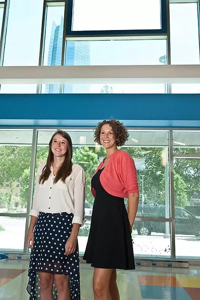 Brittney Bierschenk, 2nd grade teacher, and Karin Rowe, Kindergarten, near the front entrance with a view of downtown, at the new John Rex School. mh