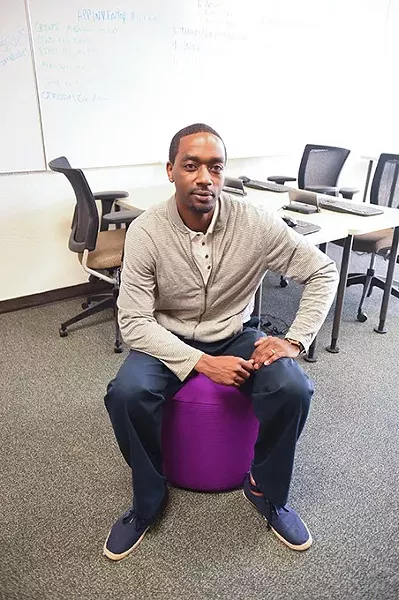 Jermaine Simpson, employment training manager at the Urban League of Greater OKC, photographed on one of the colorful atamans in the Dell Collaborative Learning Lab at the Urban League. mh