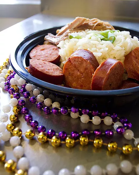 Red Beans and Rice with "pernil" Pork(puerto rican style) and smoked sausage framed with mardi gras beads at La Gumbo Ya-Ya food truck in Oklahoma City, Saturday, July 25, 2015. - KEATON DRAPER