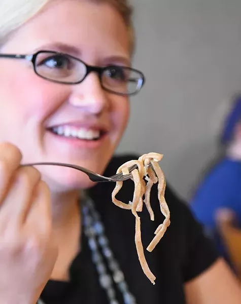 Erin Yarbrough enjoys the whole wheat Linguine at Victoria's Pasta Shop in Norman. mh