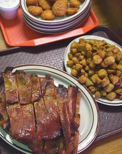 Ribs, okra, and fried pickles ar part of this Family Pack order at Spencers Smokehouse & Barbeque. mh