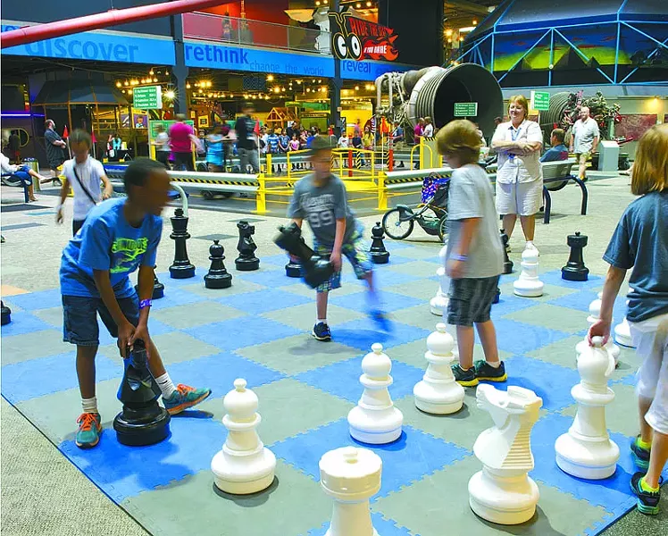 Kids enjoy playing chess with oversized pieces at Science Museum Oklahoma.Photo/Shannon Cornman - SHANNON CORNMAN