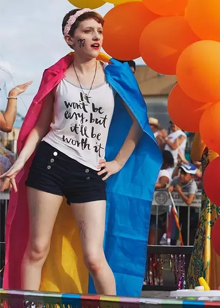 A younger participant in the Pride Parade dances to music on a float during the 30th annual Pride Celebration on Sunday, June 25, 2017. (Cara Johnson).