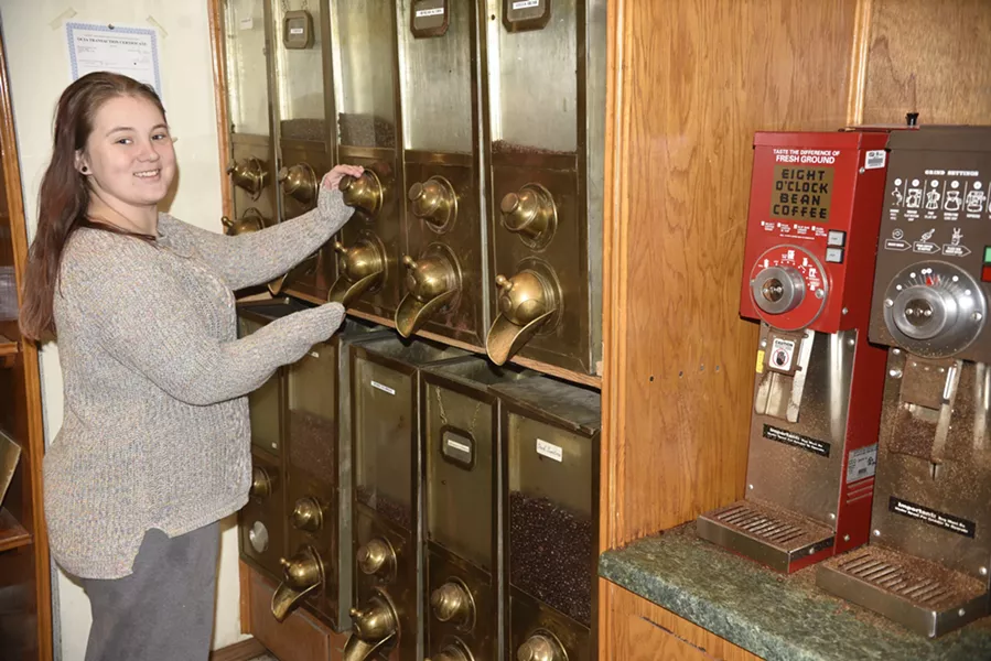 Cassidy Oldham retrieves roasted coffee beans from US Roaster Corp’s Coffee Dan’s shop. (Photo Jacob Threadgill)