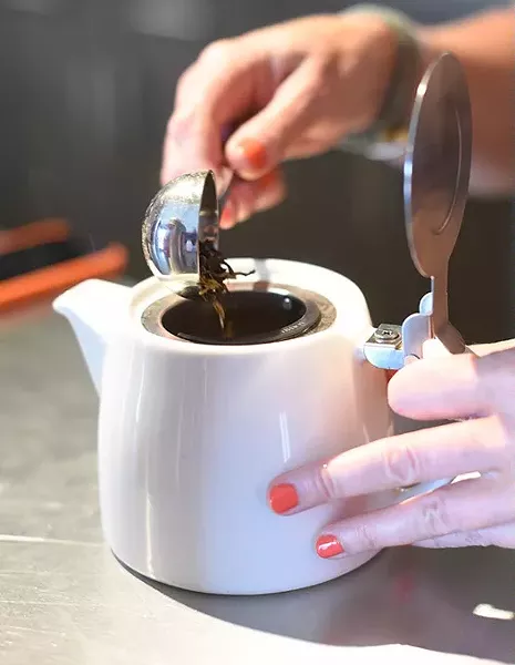 Kristy Jennins, owner, makes tea at Urban Tea House, Wednesday, May 11, 2016. - GARETT FISBECK