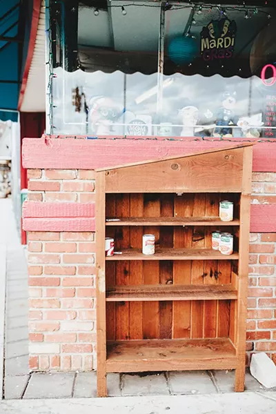 Plaza District community members refill Pine Pantry in front of Bad Granny’s - Bazaar almost nightly. - ALEXA ACE
