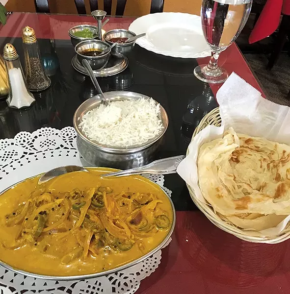 Malabar fish curry with kerala paratha, a layered flatbread from southern India - JACOB THREADGILL