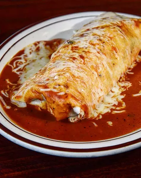 A “wet” burrito covered in red sauce and cheese is one of the most popular items at Tacos Don Nacho. - GAZETTE / FILE